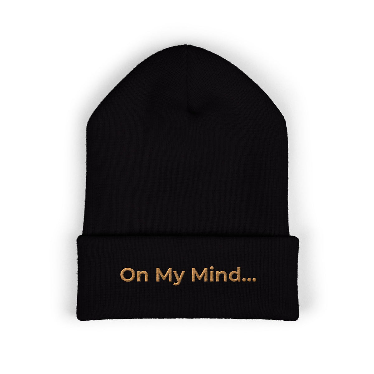Black cuffed beanie with gold “On My Mind...” embroidery on the front.